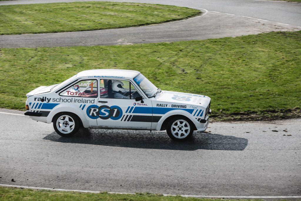 Rally car on track at Rally School Ireland, showcasing driving skills and performance in a motorsport event.