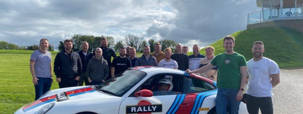 Corporate Entertainment - Group smiling after taking on the PORSCHE TOP TEAM RALLY CHALLENGE