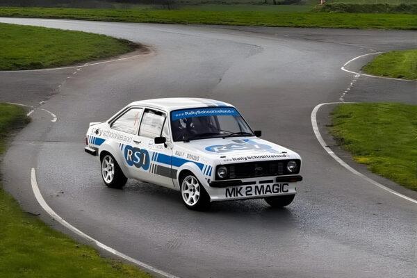 Classic rally car on a winding track showcasing dynamic driving skills and performance at Rally School Ireland.